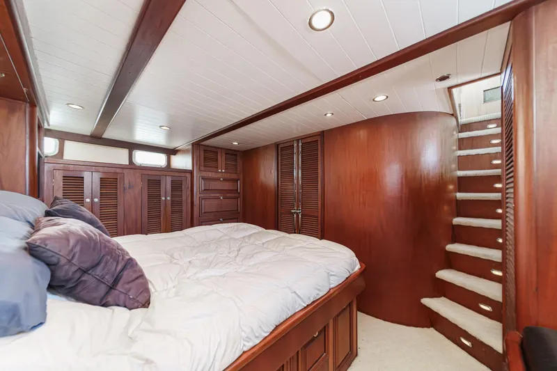 Slide: The Image of Luxurious 1963 DeFever Custom yacht bedroom with wooden interior and cozy bedding. - 13