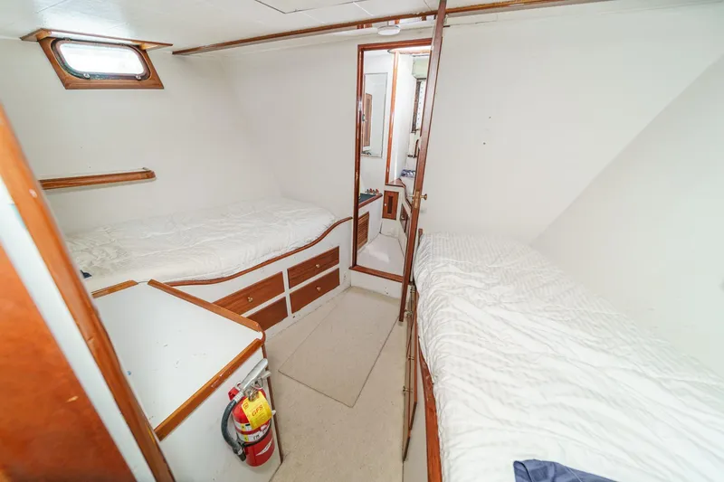 Slide: The Image of 1963 DeFever Custom Skallerud & Sons cabin interior with twin beds and wooden accents. - 17