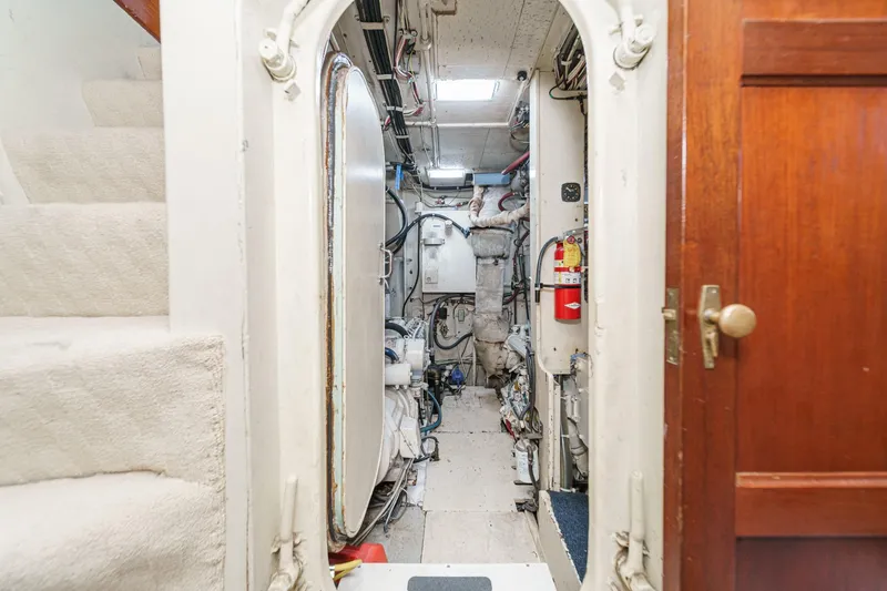 Slide: The Image of Engine room of 1963 DeFever Custom Skallerud & Sons boat, featuring machinery and fire extinguisher. - 19