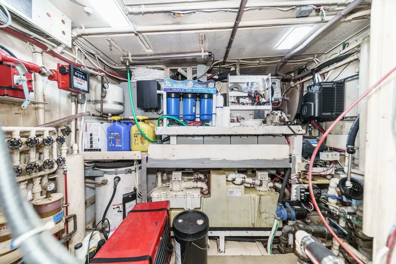 Slide: The Image of Engine room of 1963 DeFever Custom Skallerud & Sons boat, featuring complex machinery and piping. - 22