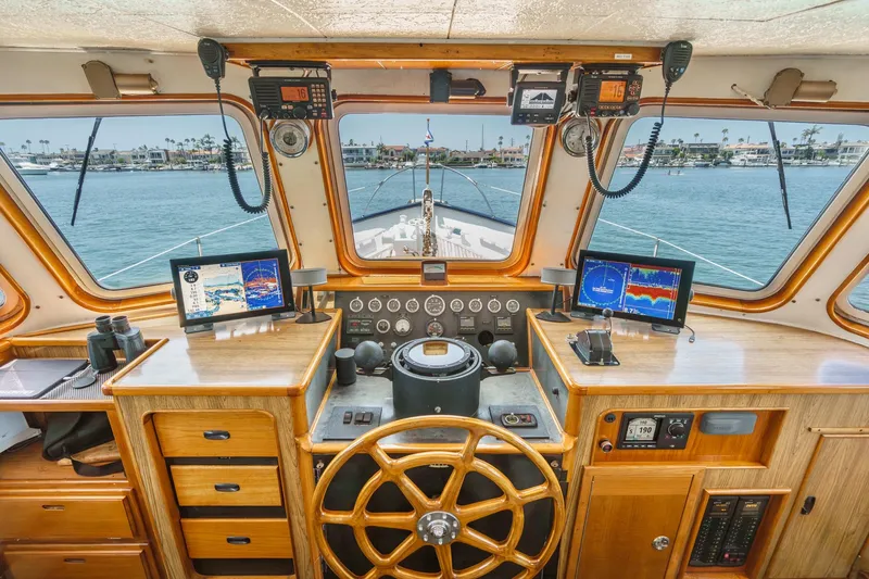 Slide: The Image of 1963 DeFever Custom Skallerud & Sons yacht helm with navigation equipment and scenic ocean view. - 5