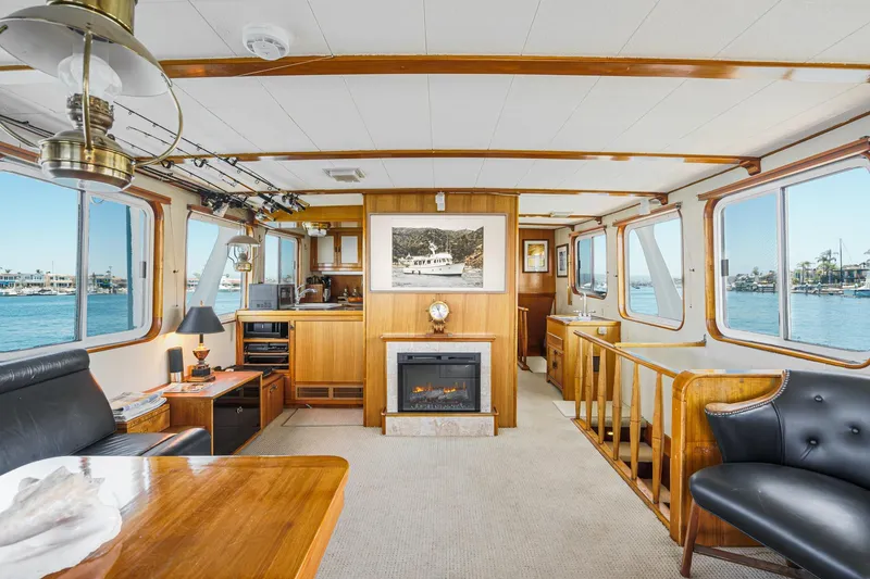 Slide: The Image of Interior of 1963 DeFever Custom Skallerud & Sons yacht with elegant wood finishes and ocean view. - 9