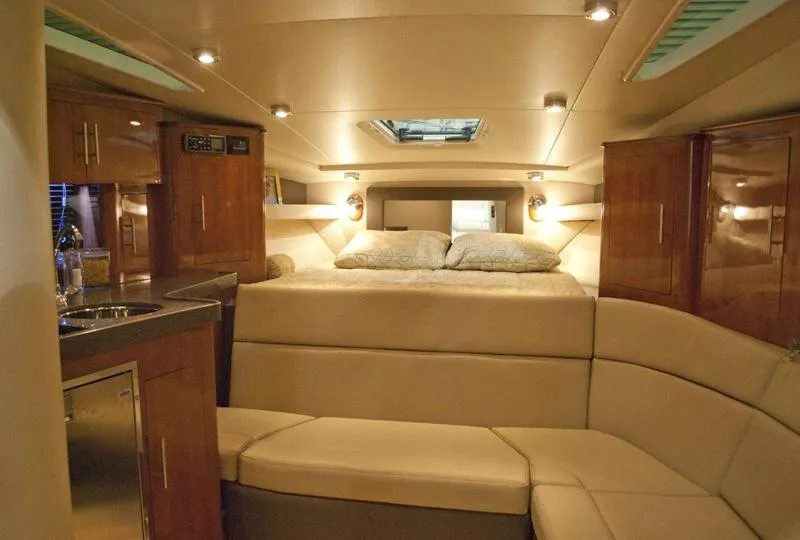 Slide: The Image of Manufacturer Provided Image: Interior cabin of a 2012 Regal 35 Sport Coupe yacht with bed and seating area. - 10