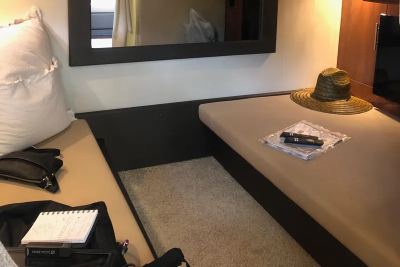 Slide: The Image of Interior cabin of 2012 Regal 35 Sport Coupe with seating, hat, and remote control. - 15