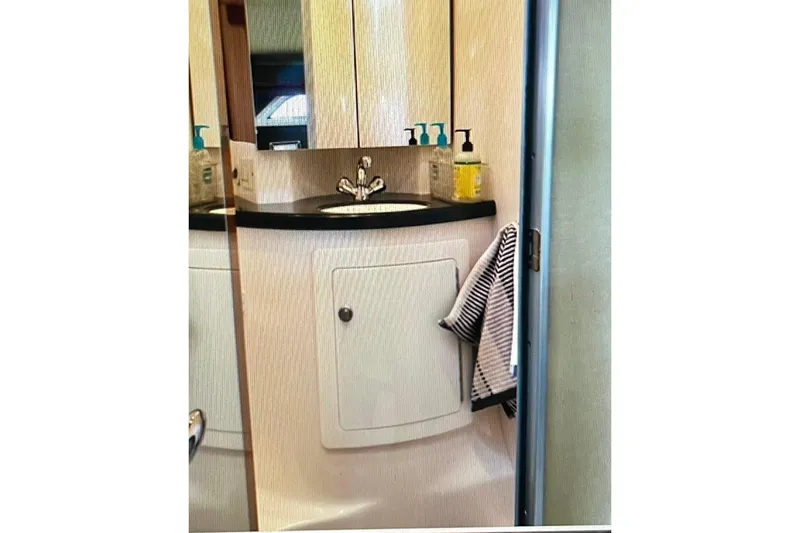 Slide: The Image of Bathroom vanity in 2012 Regal 35 Sport Coupe yacht, featuring sink and toiletries. - 17
