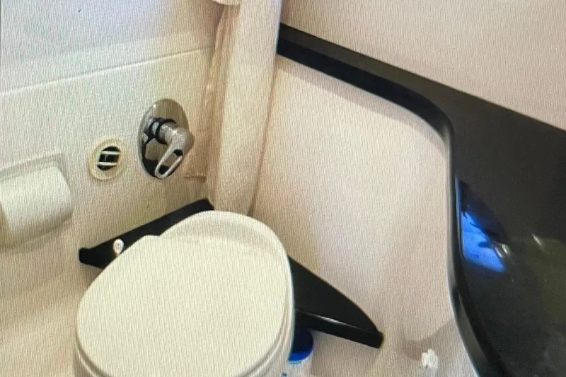 Slide: The Image of 2012 Regal 35 Sport Coupe bathroom with toilet and sleek countertop design. - 18