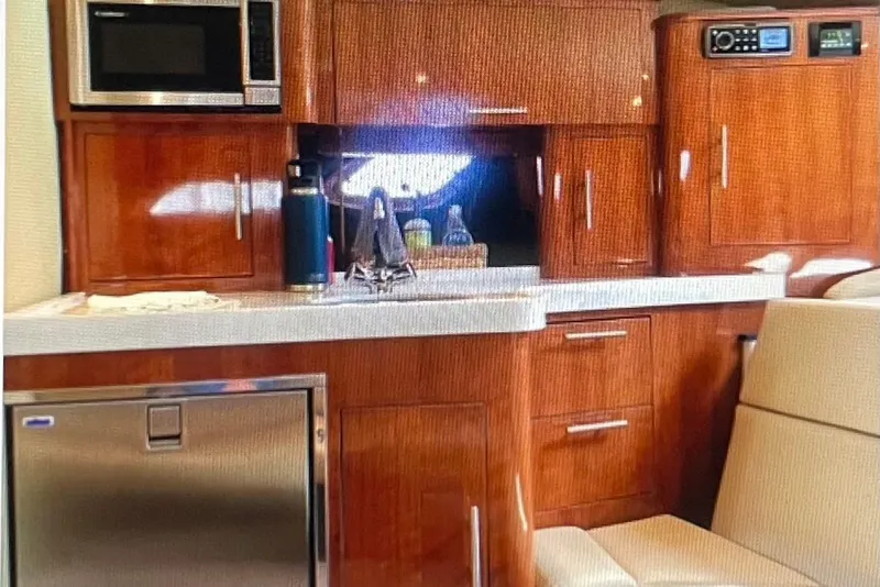 Slide: The Image of Luxurious 2012 Regal 35 Sport Coupe interior with wood cabinetry and modern appliances. - 19