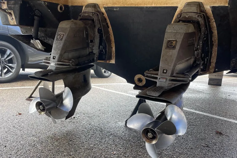 Slide: The Image of 2012 Regal 35 Sport Coupe boat propellers and outdrives in a parking lot. - 20