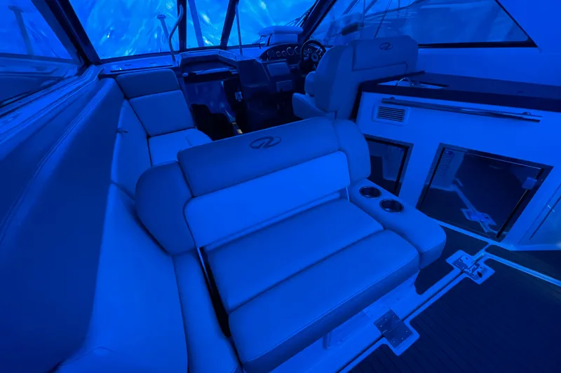 Slide: The Image of Interior of 2012 Regal 35 Sport Coupe boat with blue ambient lighting. - 21