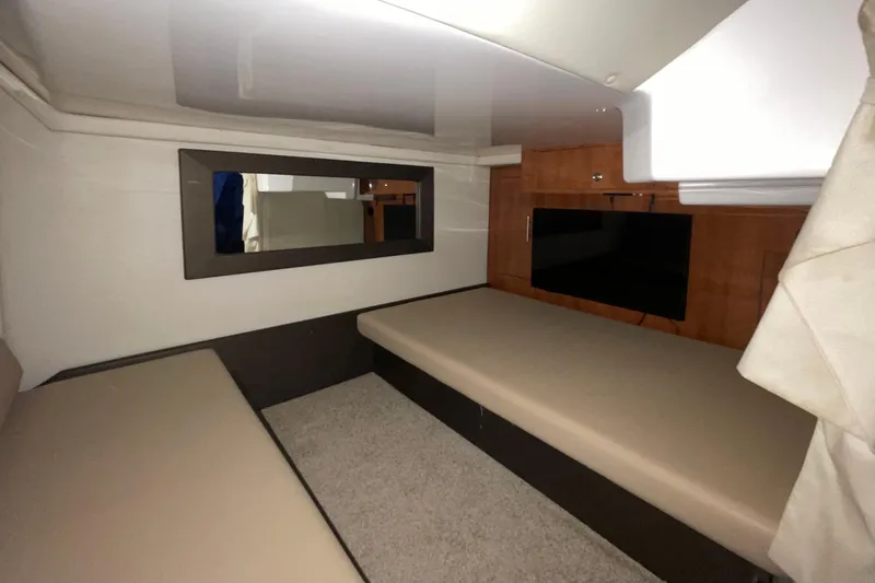 Slide: The Image of Interior cabin of 2012 Regal 35 Sport Coupe with beige seating and wall-mounted TV. - 26