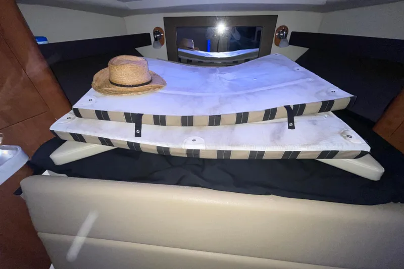 Slide: The Image of Luxurious cabin interior of 2012 Regal 35 Sport Coupe with cozy bedding and decorative pillows. - 34