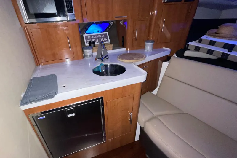 Slide: The Image of Luxurious cabin interior of 2012 Regal 35 Sport Coupe with cozy bedding and decorative pillows. - 35