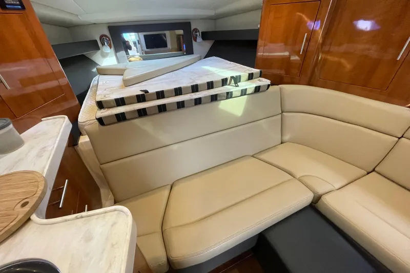 Slide: The Image of Interior cabin of 2012 Regal 35 Sport Coupe with beige seating and wall-mounted TV. - 42