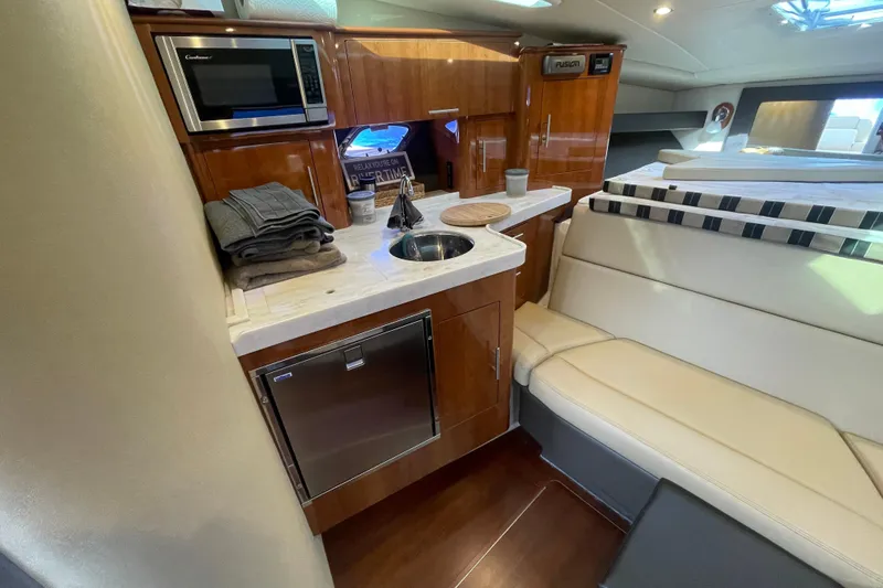 Slide: The Image of Interior seating of a 2012 Regal 35 Sport Coupe with beige cushions. - 43
