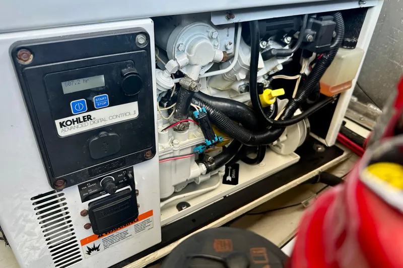 Slide: The Image of Kohler generator control panel inside 2012 Regal 35 Sport Coupe boat engine compartment. - 53