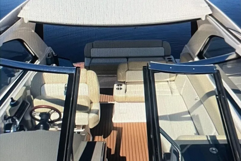 Slide: The Image of 2012 Regal 35 Sport Coupe interior with beige seating and wooden flooring. - 7