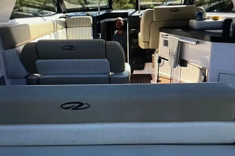 Slide: The Image of Interior of a 2012 Regal 35 Sport Coupe boat with seating and kitchenette. - 8