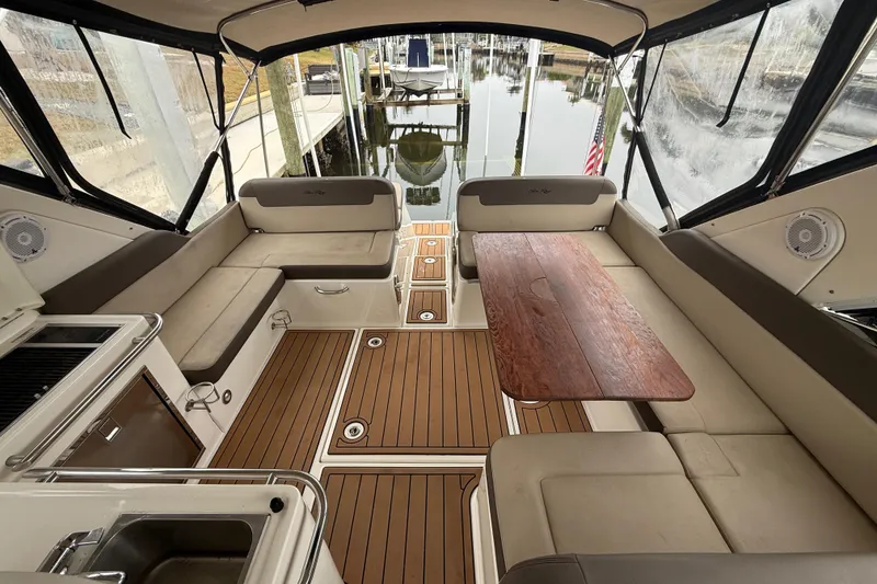 Slide: The Image of Luxurious interior of 2014 Sea Ray 370 Venture yacht with seating and wooden table. - 14