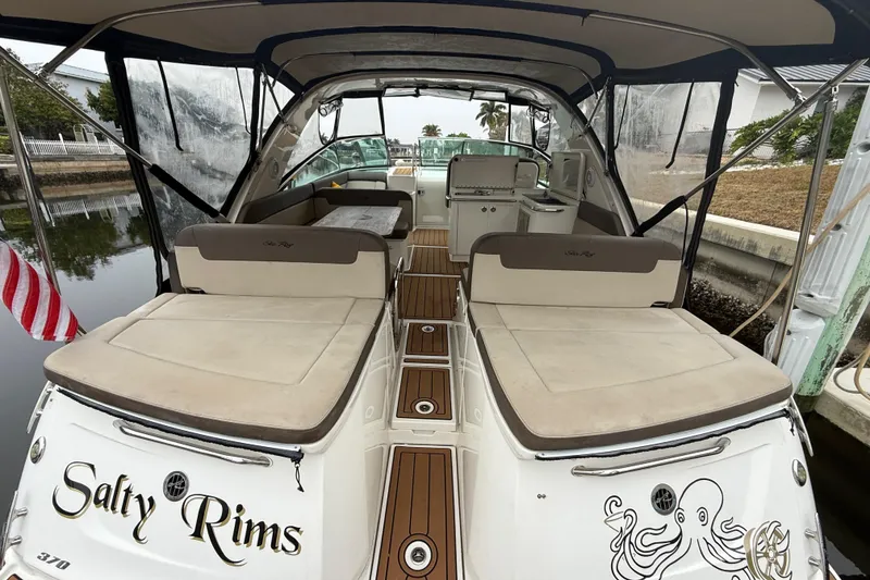 Slide: The Image of 2014 Sea Ray 370 Venture boat with cushioned seating and "Salty Rims" name on the stern. - 15