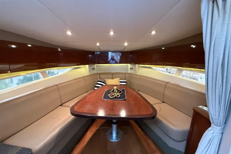 Slide: The Image of Luxurious interior of 2014 Sea Ray 370 Venture yacht with elegant seating and wooden table. - 19