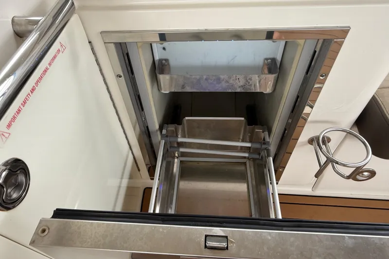 Slide: The Image of Open storage compartment on 2014 Sea Ray 370 Venture boat, featuring stainless steel details. - 25