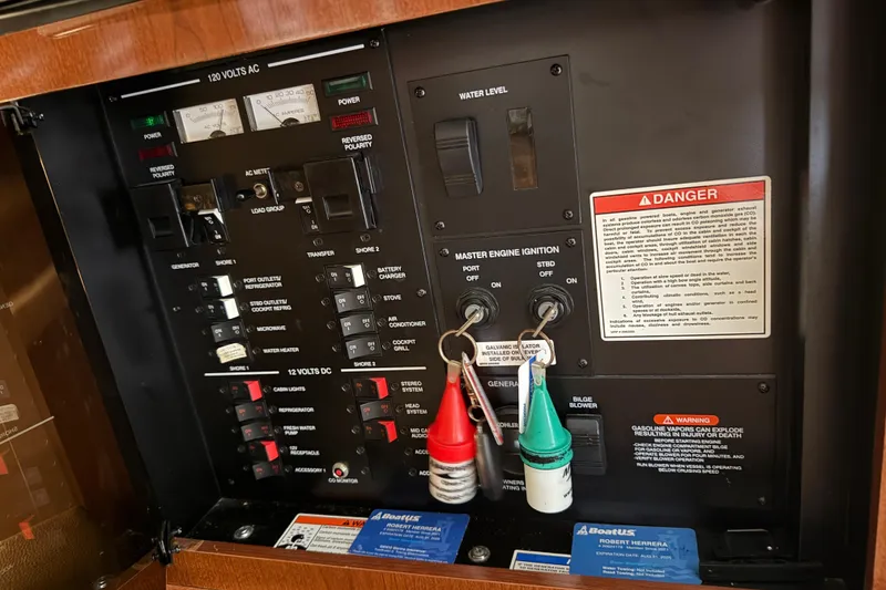 Slide: The Image of Control panel of a 2014 Sea Ray 370 Venture boat with warning labels and switches. - 27