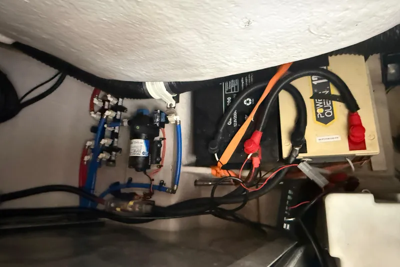 Slide: The Image of Electrical components and wiring inside a 2014 Sea Ray 370 Venture boat. - 28