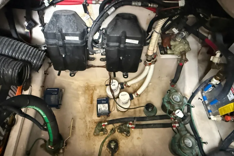 Slide: The Image of Engine compartment of a 2014 Sea Ray 370 Venture boat, showing various mechanical components. - 29