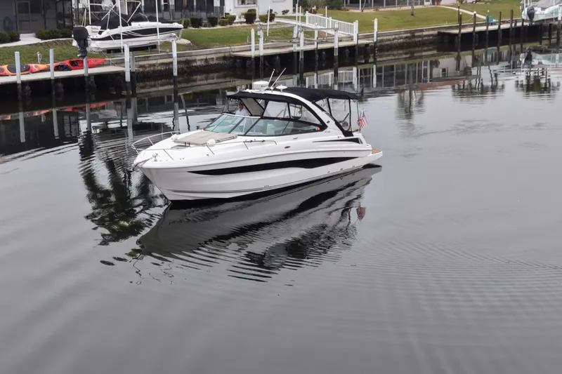 Slide: The Image of 2014 Sea Ray 370 Venture boat on calm water near a dock. - 4
