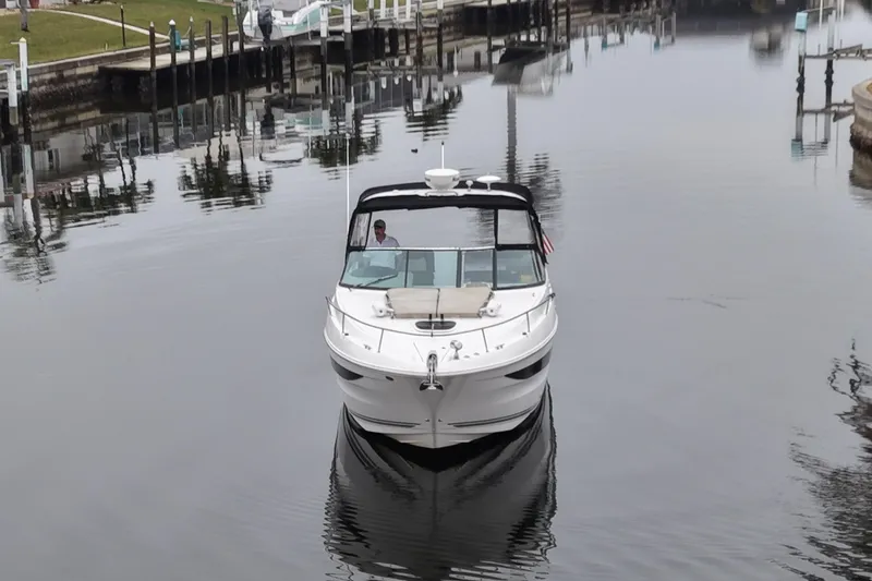 Slide: The Image of 2014 Sea Ray 370 Venture boat cruising in a calm marina. - 5