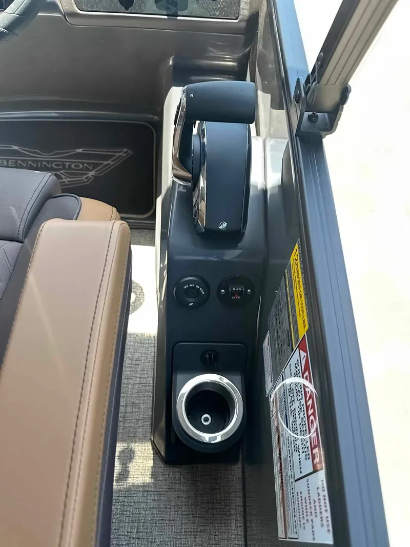 Slide: The Image of Close-up of a Bennington 24 MSL helm with controls and a cup holder. - 18