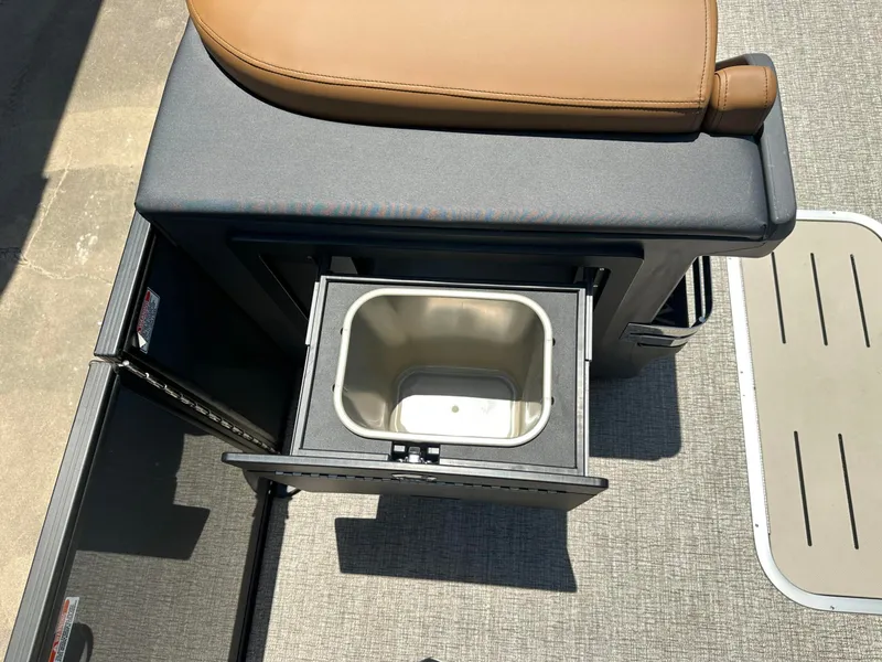 Slide: The Image of An open storage compartment with a pull-out tray on a boat with gray flooring. - 6