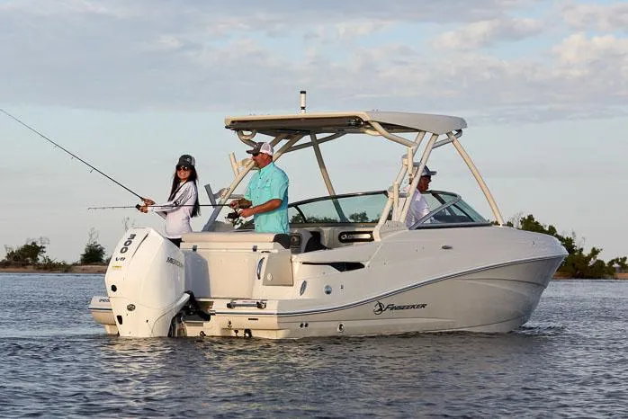 Slide: The Image of 2024 Finseeker 240 DC boat docked on a sunny day with blue skies. - 2