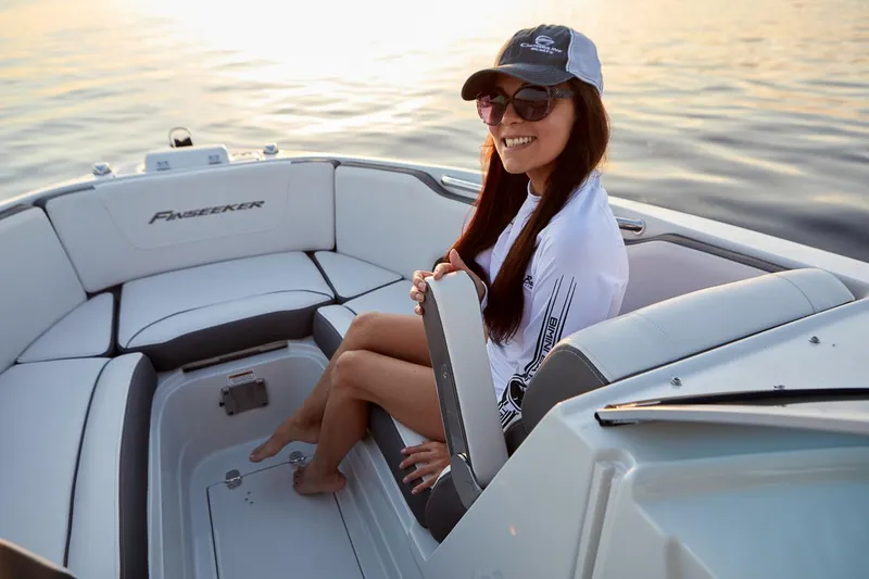 Slide: The Image of 2024 Finseeker 240 DC boat docked, featuring sleek design and comfortable seating. - 3