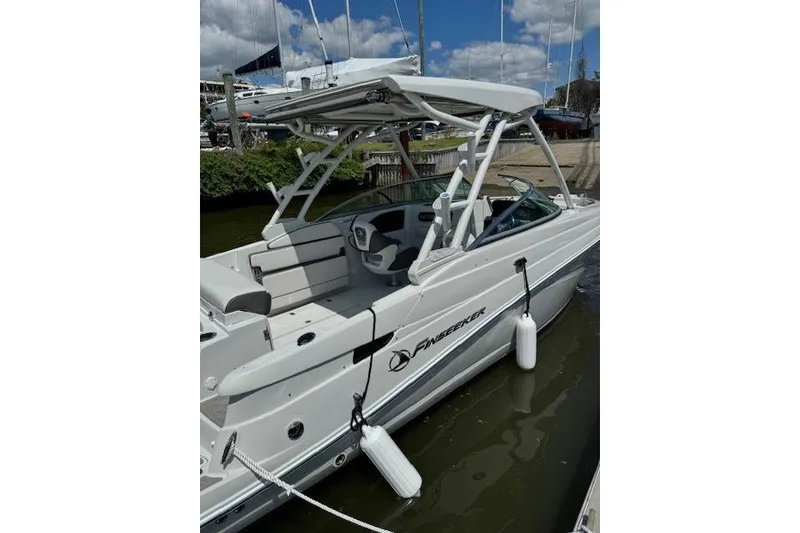 Slide: The Image of 2024 Finseeker 240 DC boat docked, featuring sleek design and modern amenities. - 4