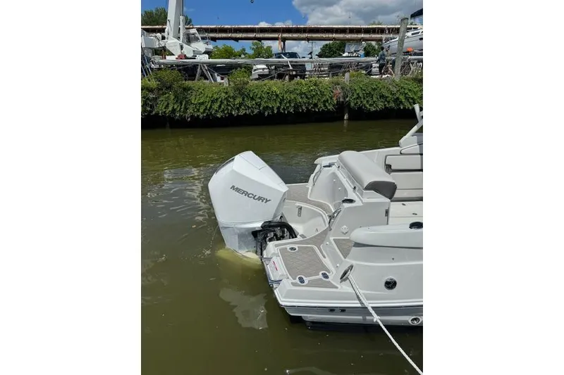 Slide: The Image of 2024 Finseeker 240 DC boat with Mercury outboard engine docked in a marina. - 5