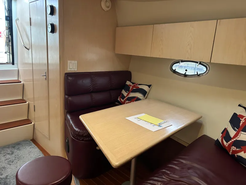 Slide: The Image of Interior of 1997 Tiara Yachts 3500 Express with cozy seating and table. - 28