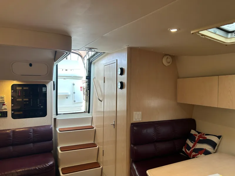 Slide: The Image of Interior of 1997 Tiara Yachts 3500 Express, featuring seating, stairs, and nautical decor. - 31