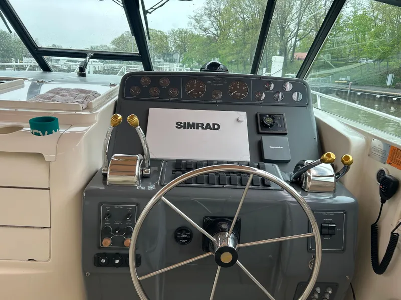 Slide: The Image of 1997 Tiara Yachts 3500 Express helm with Simrad navigation system and dual throttle controls. - 35
