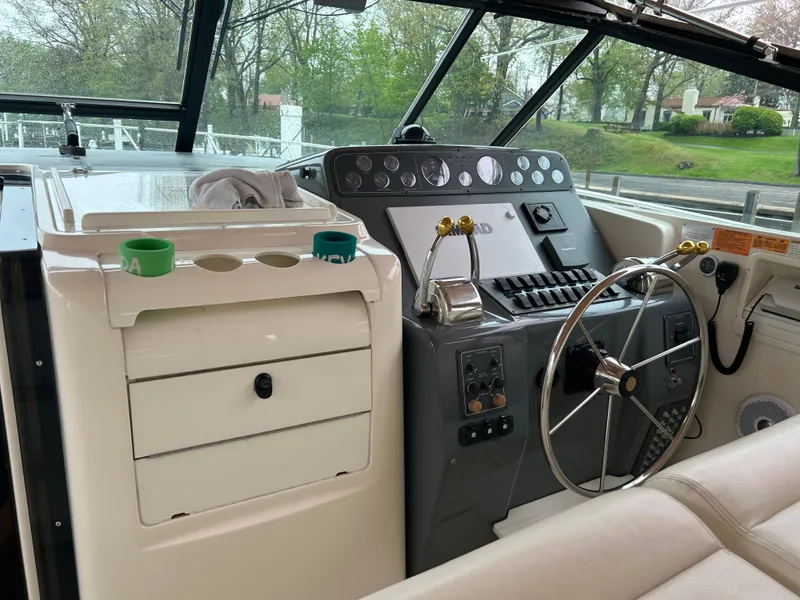 Slide: The Image of 1997 Tiara Yachts 3500 Express helm with steering wheel and control panel. - 38
