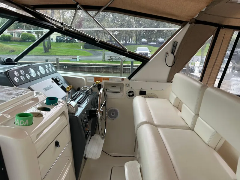Slide: The Image of 1997 Tiara Yachts 3500 Express interior with helm, seating, and dashboard controls. - 43