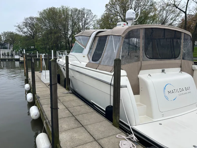 Slide: The Image of 1997 Tiara Yachts 3500 Express docked, featuring a sleek white exterior and covered cockpit. - 45