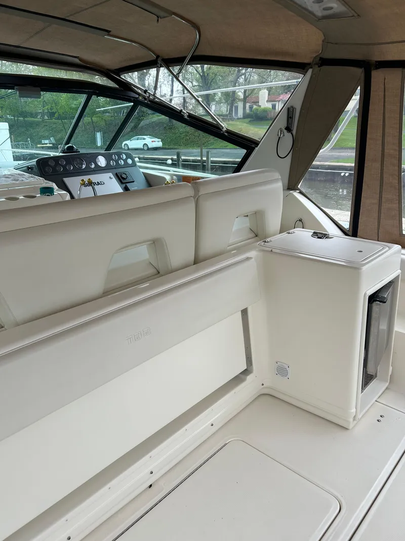 Slide: The Image of 1997 Tiara Yachts 3500 Express interior with helm and seating area. - 48