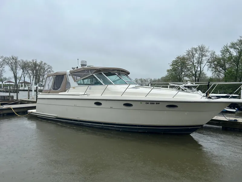 Slide: The Image of 1997 Tiara Yachts 3500 Express docked on a cloudy day. - 8