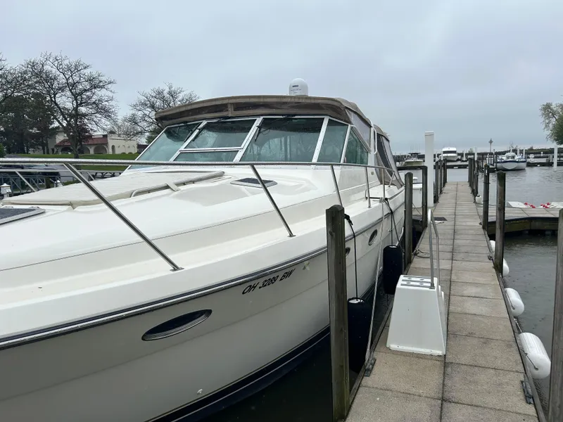 Slide: The Image of 1997 Tiara Yachts 3500 Express docked at marina on a cloudy day. - 9