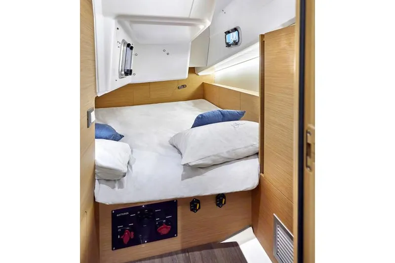 Slide: The Image of Manufacturer Provided Image: Cozy cabin interior of 2026 Jeanneau Sun Odyssey 380 sailboat with comfortable bedding. - 12