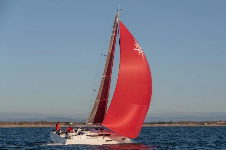 Slide: The Image of Manufacturer Provided Image: 2026 Jeanneau Sun Odyssey 380 sailing with a vibrant red sail on open water. - 6