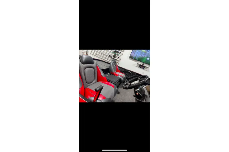 Slide: The Image of 2020 Ranger Z520C Cup-Equipped boat interior with red and gray seats, steering console. - 6