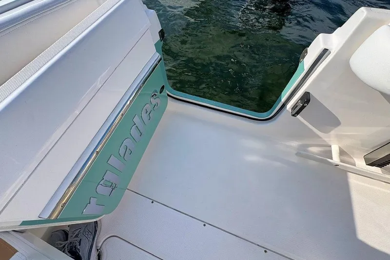 Slide: The Image of 2012 Everglades 295 Center Console boat interior with open door, showing water view. - 11