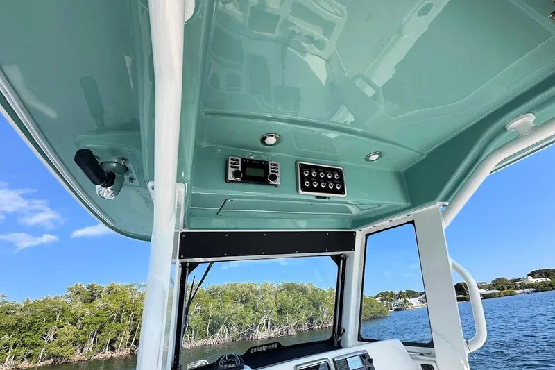 Slide: The Image of 2012 Everglades 295 Center Console boat interior with control panel, on a sunny day. - 13